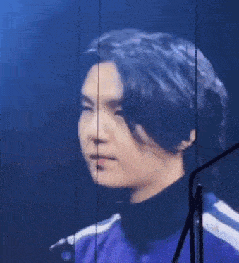 a close up of a person 's face with a microphone in the background .