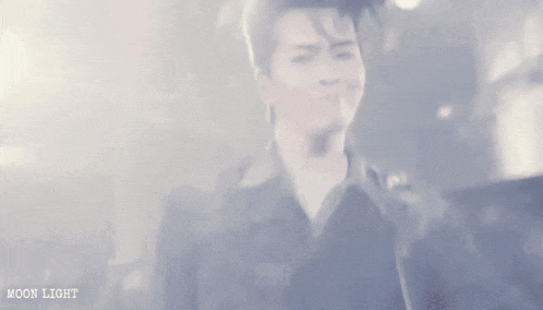 a blurry picture of a man in a military uniform with the word moon light on the bottom