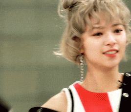 a woman with blonde hair is wearing a red white and black dress