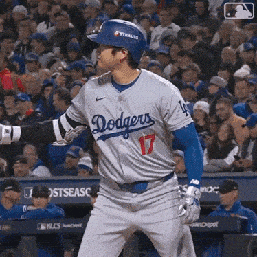 a baseball player wearing a dodgers jersey and number 17