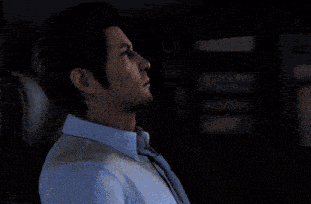 a man in a blue shirt and tie is looking out a car window