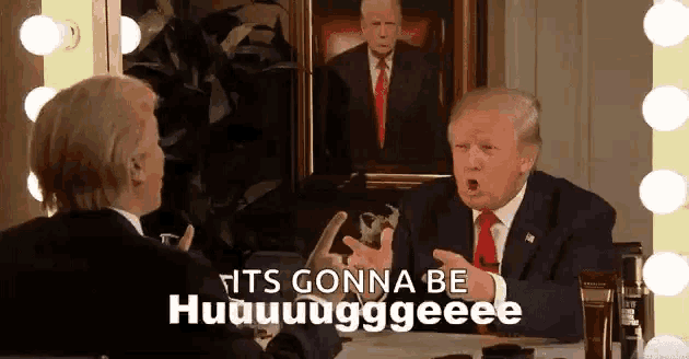 a man in a suit and tie is talking to another man in front of a painting of trump .