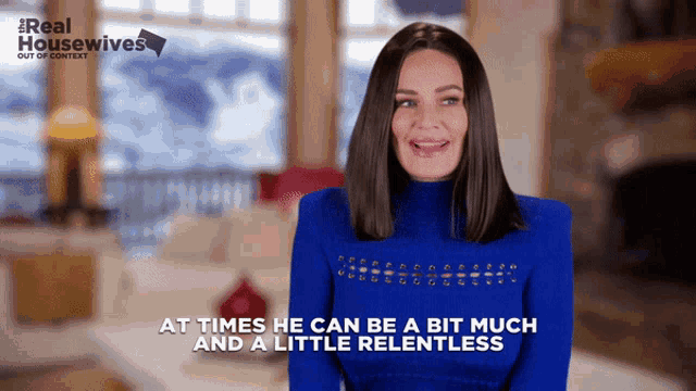 a woman in a blue sweater with the words at times he can be a bit much and a little relentless below her