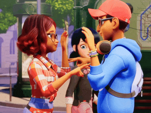 a boy in a blue hoodie is touching a girl 's head