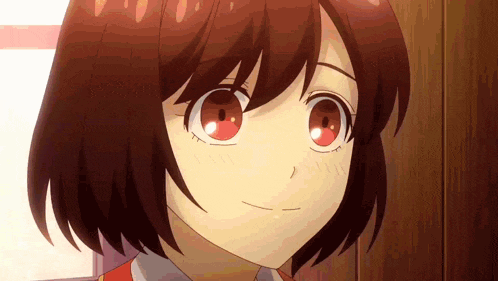 a close up of a girl 's face with red eyes and short red hair .
