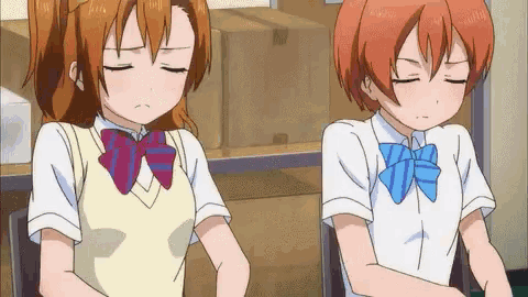 two anime girls are sitting next to each other with their eyes closed ..