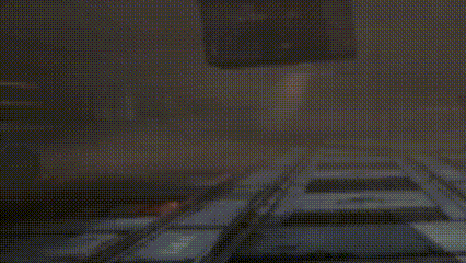 a blurred image of a robot standing on top of a building in a dark room .