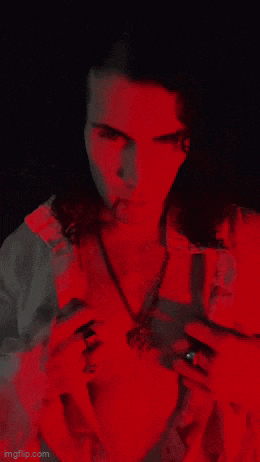 a woman in a vampire costume with blood on her face
