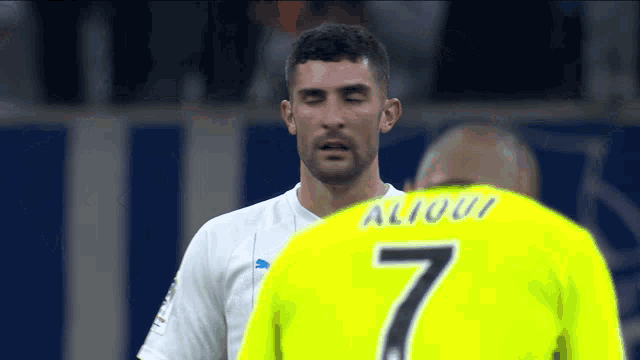a man wearing a yellow jersey with the number 7 on it