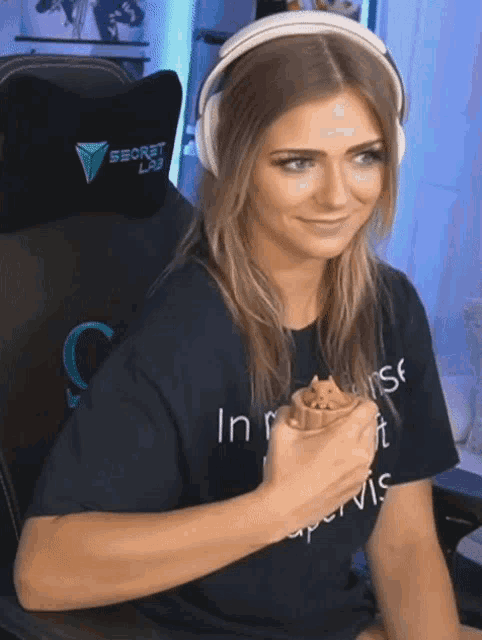 a woman wearing headphones and a shirt that says secret lab
