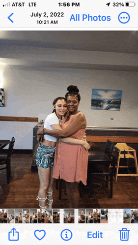 a phone screen shows a photo of two women hugging on july 2 2022