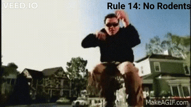 a man wearing sunglasses is riding a bike with the words rule 14 no rodent written above him