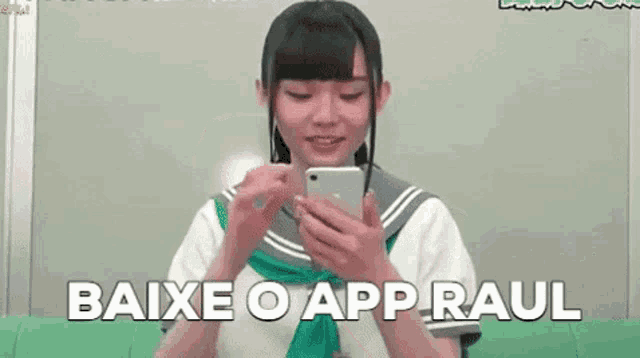 a girl in a sailor suit is holding a cell phone in her hands .