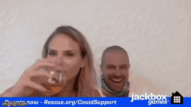 a man and a woman are drinking from a glass with a jackbox games logo behind them