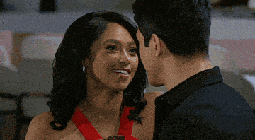 a man and woman are looking at each other and the woman is smiling