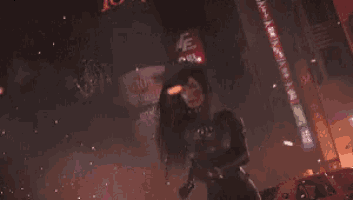 a woman holding a gun in front of a sign that says 10