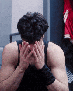 a man is covering his face with his hands