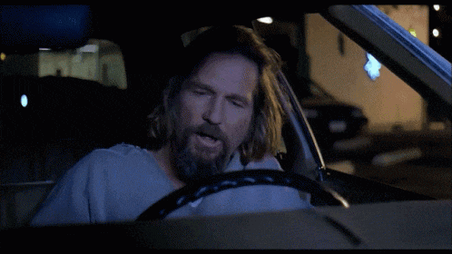 a man driving a car with the words you 're just an asshole below him