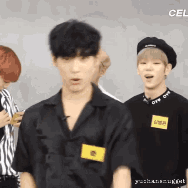 a man in a black shirt with a name tag that says yuchansnugget
