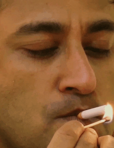 a man lighting a match in his mouth