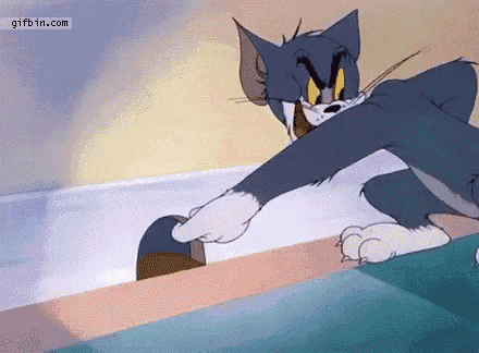a cartoon cat is playing with a mouse .