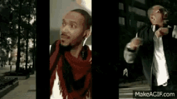 a man wearing headphones and a scarf is standing on a sidewalk .