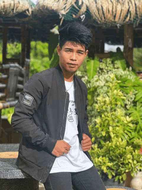 a young man wearing a black jacket and a white t-shirt that says i 'm a tiger