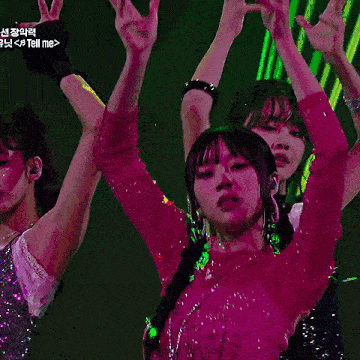 a woman in a pink top is dancing in front of a purple background that says tell me