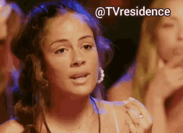 a woman with a ring on her finger stands in a crowd with the words @tvresidence above her