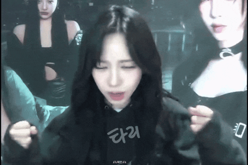 a girl wearing a black hoodie with the word aria on the front