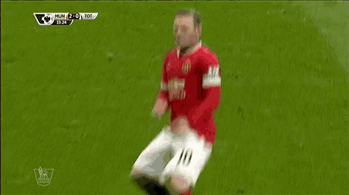 a soccer player with the number 10 on his jersey is laying on the field