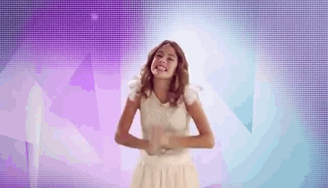 a woman in a white dress is dancing on a purple background .