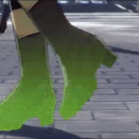 a close up of a person 's feet in green boots walking on a brick sidewalk .