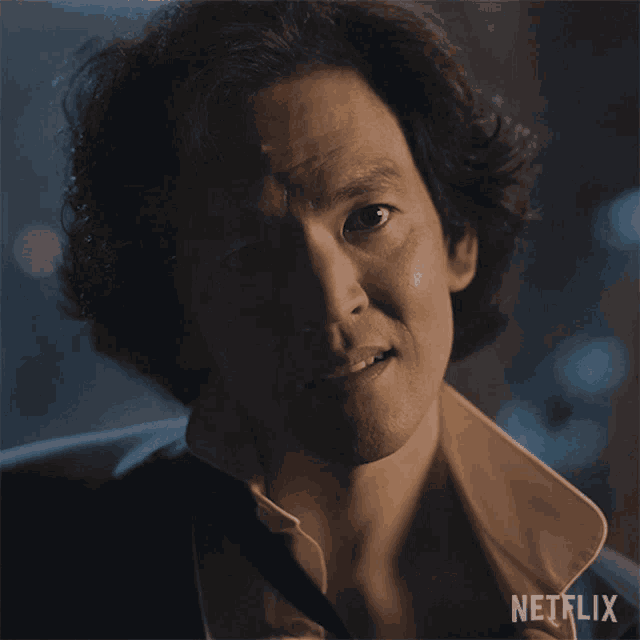 a close up of a man 's face with netflix written on the bottom right