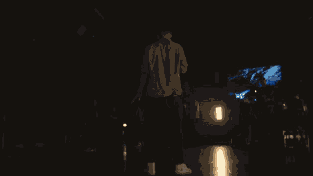 a man stands in front of a blue smokey background