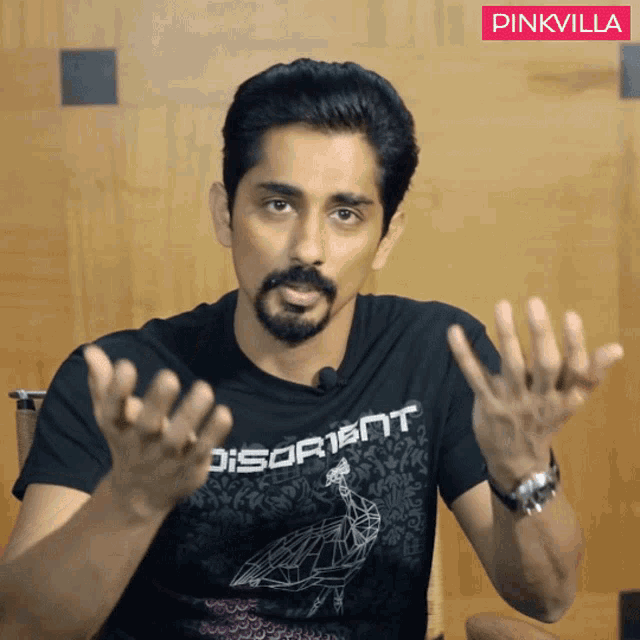 a man wearing a black shirt that says " disorient "