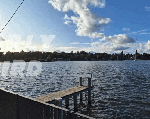 a large body of water with a dock in the foreground and the word sky behind it