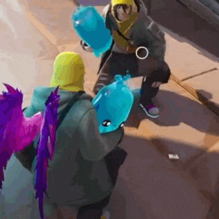 a group of people are standing next to each other on a sidewalk holding balloons .