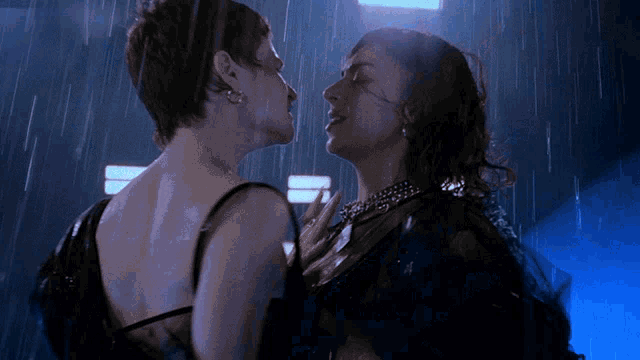 a couple of women kissing in the rain