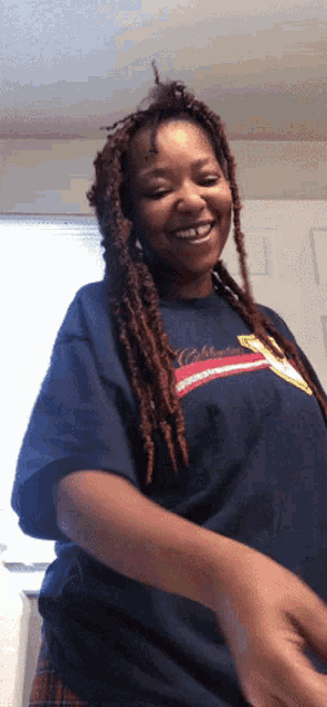 a woman wearing a shirt that says california on it