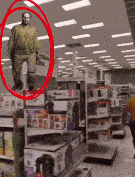 a man is standing in front of a sign that says more