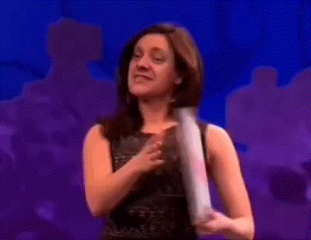 a woman in a black dress holds a piece of paper in her hands