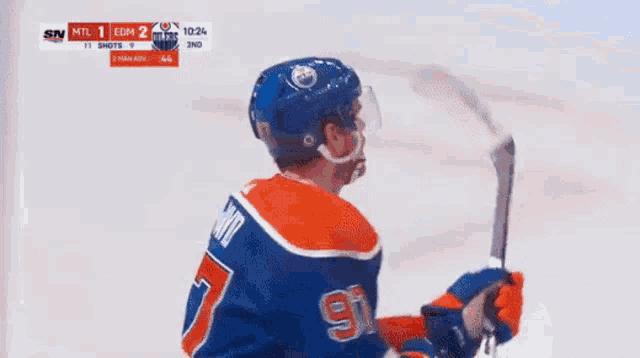a hockey player wearing a jersey with the name mcdavid on the back
