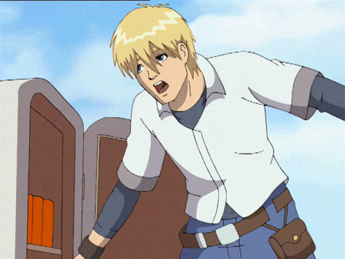 a man in a white shirt and blue jeans is standing in front of a door