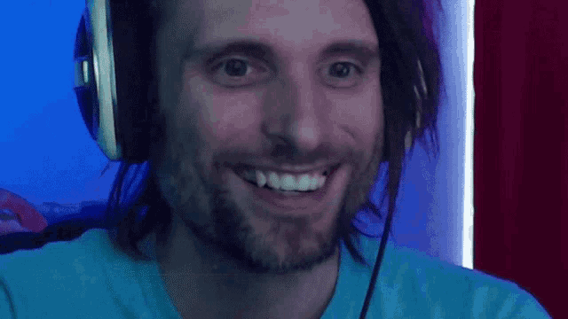 a man with long hair and a beard wearing headphones