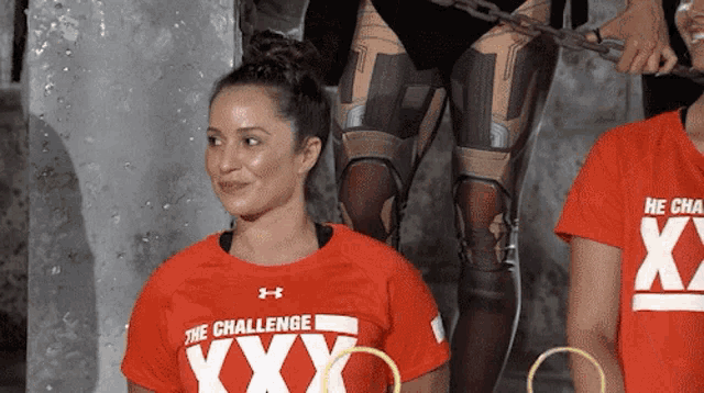 a woman in a red shirt that says the challenge xx