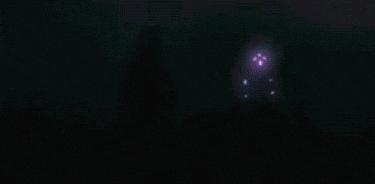 a blurred image of a boat in the water at night .