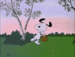 snoopy is holding a basket in a grassy field .