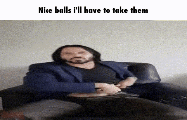 a man with a beard is sitting on a couch with a caption that says nice balls