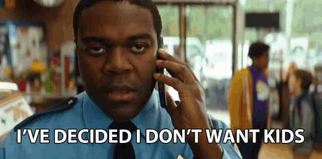 a man talking on a cell phone with the words " i 've decided i don 't want kids " behind him